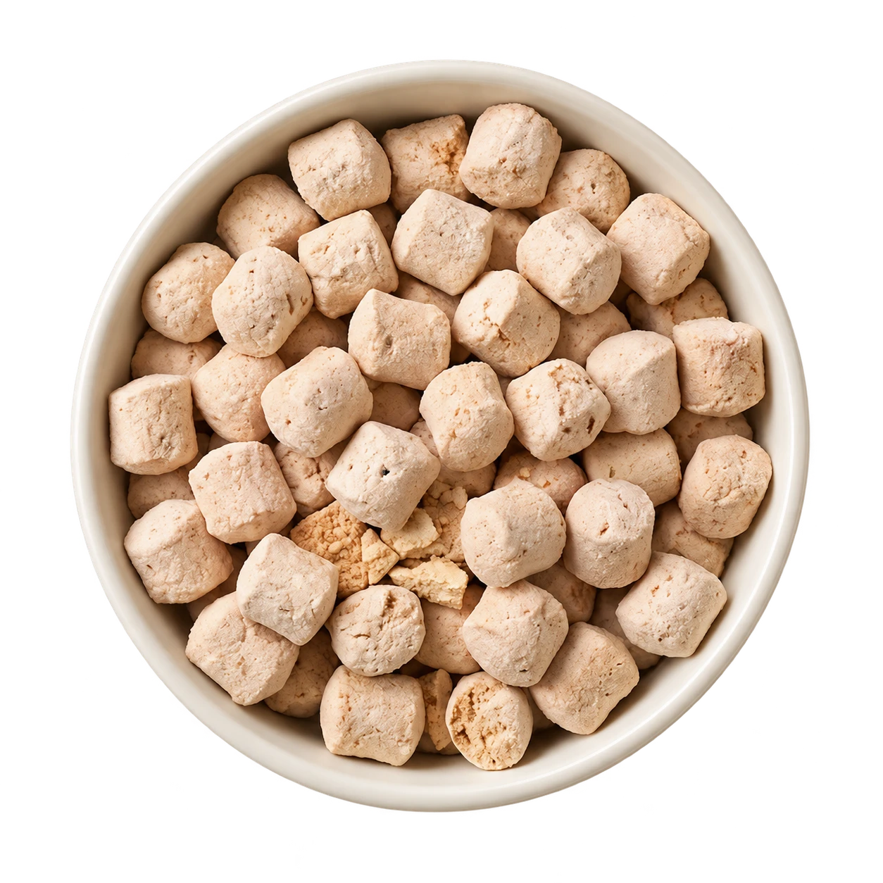 A bowl of pale freeze-dried raw nuggets, seen from above.